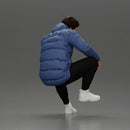 Street performer crouching low in blue puffer jacket athletic stance sitting - Only-Games