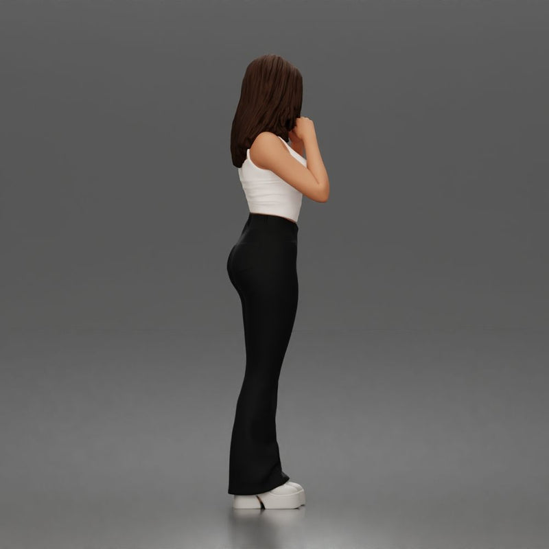 Thoughtful woman stands daydreaming wearing crop tank top and trousers - Only-Games