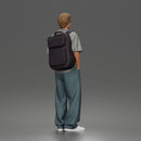Student standing with backpack wearing oversized tee and baggy jeans