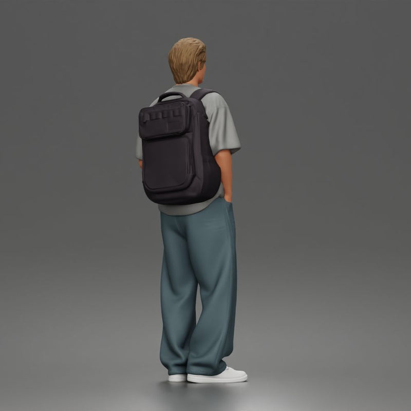 Student standing with backpack wearing oversized tee and baggy jeans