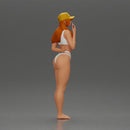 girl in a white bikini holding a phone on the beach and wearing a cap - Only-Games