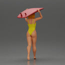 woman in yellow swimsuit carrying a red surfboard on her shoulders - Only-Games