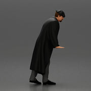 Man in black coat wearing flat cap standing with serious expression - Only-Games