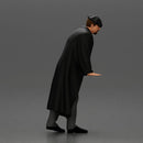 Man in black coat wearing flat cap standing with serious expression - Only-Games