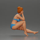 Woman sitting in Blue Bikini Ponders with Relaxed Posture - Only-Games