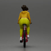 Sporty girl riding a red bike in bright yellow tracksuit - Only-Games