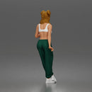 Woman With Crossed Legs Wearing Sports Bra Joggers And Sneakers - Only-Games