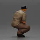 Gangster man crouching in a relaxed pose wearing casual clothing and cap - Only-Games