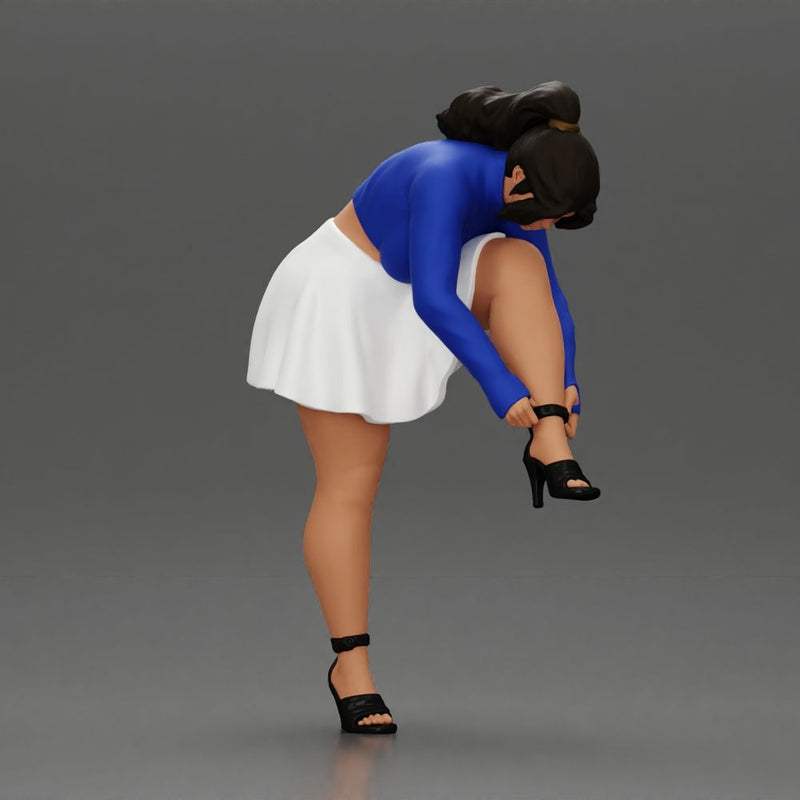 Young woman in skirt adjusts her elegant black high heeled shoes - Only-Games