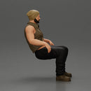 Muscular Bearded Man in Beanie Vest Pants Sitting Casually Relaxed - Only-Games