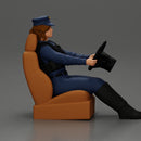 Focused officer in blue uniform driving seated holding steering wheel - Only-Games