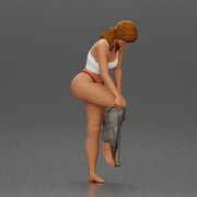 Woman in white top carefully wearing grey pants with balance - Only-Games