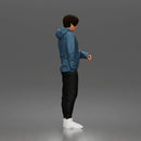 Casual Young Man Standing Relaxed in Hoodie, Joggers, and Sneakers