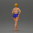 woman posing barefoot wearing bikini top and shorts stylishly - Only-Games