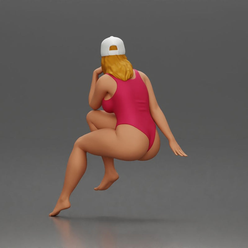 Woman in Swimsuit and Cap Sitting Thoughtfully in Relaxed Pose - Only-Games