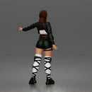 Woman Posing With Arm Extended In Crop Jacket Bralette Leather Shorts And Strappy Boots
