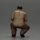Gangster man crouching in a relaxed pose wearing casual clothing and cap - Only-Games