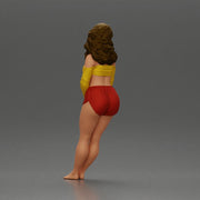 Woman in yellow top and red shorts leaning to wall - Only-Games