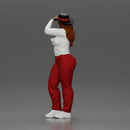 woman in red pants striking stylish pose with hat - Only-Games