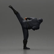 Ninja in black uniform performs high side kick with precision - Only-Games