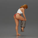 Woman in white top carefully wearing grey pants with balance - Only-Games