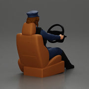 Focused officer in blue uniform driving seated holding steering wheel - Only-Games