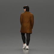 Man in brown coat glances sideways dressed in stylish winterwear - Only-Games