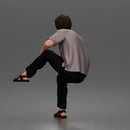 Man Sitting With Knee Bent In Shirt Trousers And Sandals