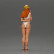 girl in a white bikini holding a phone on the beach and wearing a cap - Only-Games