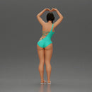 Brunette woman in turquoise swimsuit stretching with elegant ballet pose - Only-Games
