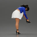 Young woman in skirt adjusts her elegant black high heeled shoes - Only-Games