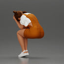 Crying girl sitting low in orange dress with head in hands - Only-Games