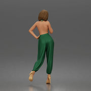 Woman poses thoughtfully lifting heel wearing halter jumpsuit with platform heels - Only-Games