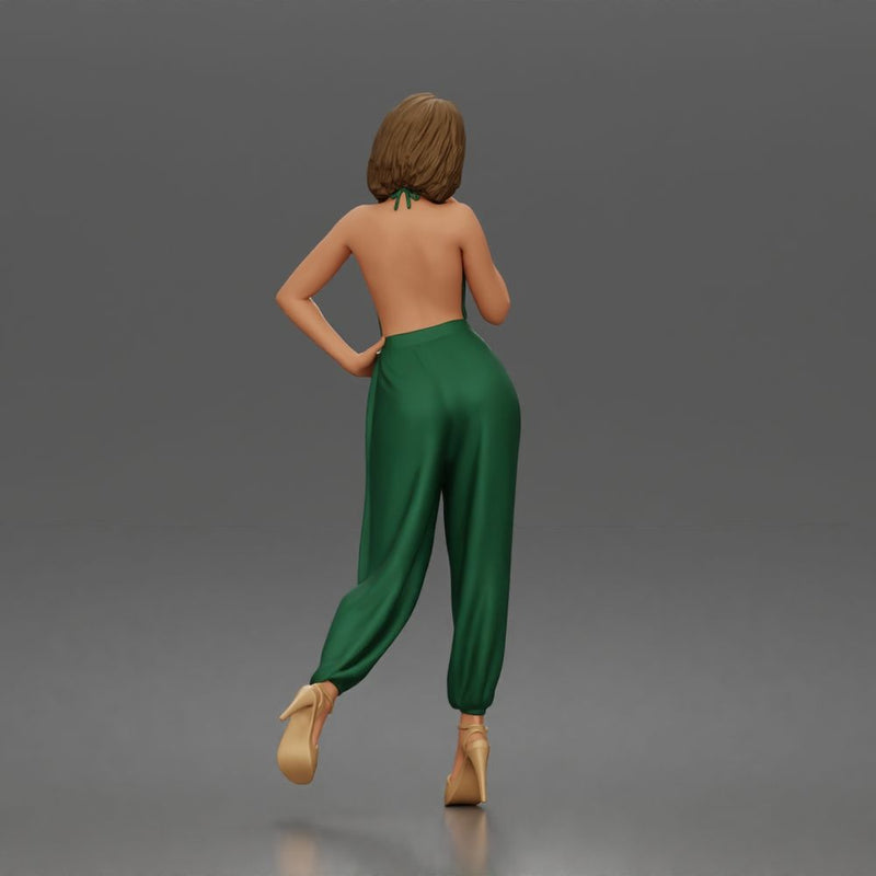 Woman poses thoughtfully lifting heel wearing halter jumpsuit with platform heels - Only-Games