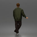 Man standing In Bomber Jacket Tee Trousers Sneakers And Sunglasses