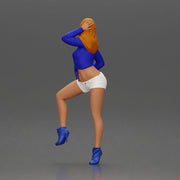 Woman in blue top and white shorts posing on a motorbike - Only-Games