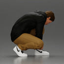 Man in hoodie crouching down tying shoelaces focused in casual outfit - Only-Games
