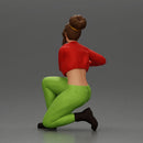 Fashionable woman kneeling in red jacket, green pants, and black boots - Only-Games