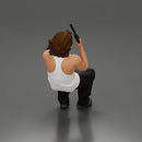 Man sitting with gun in hand pointing forward calmly - Only-Games