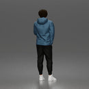 Casual Young Man Standing Relaxed in Hoodie, Joggers, and Sneakers