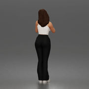 Thoughtful woman stands daydreaming wearing crop tank top and trousers - Only-Games