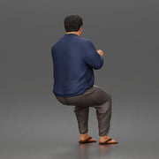 Asian Man sits gesturing while wearing casual sweater pants flip flops comfortably - Only-Games