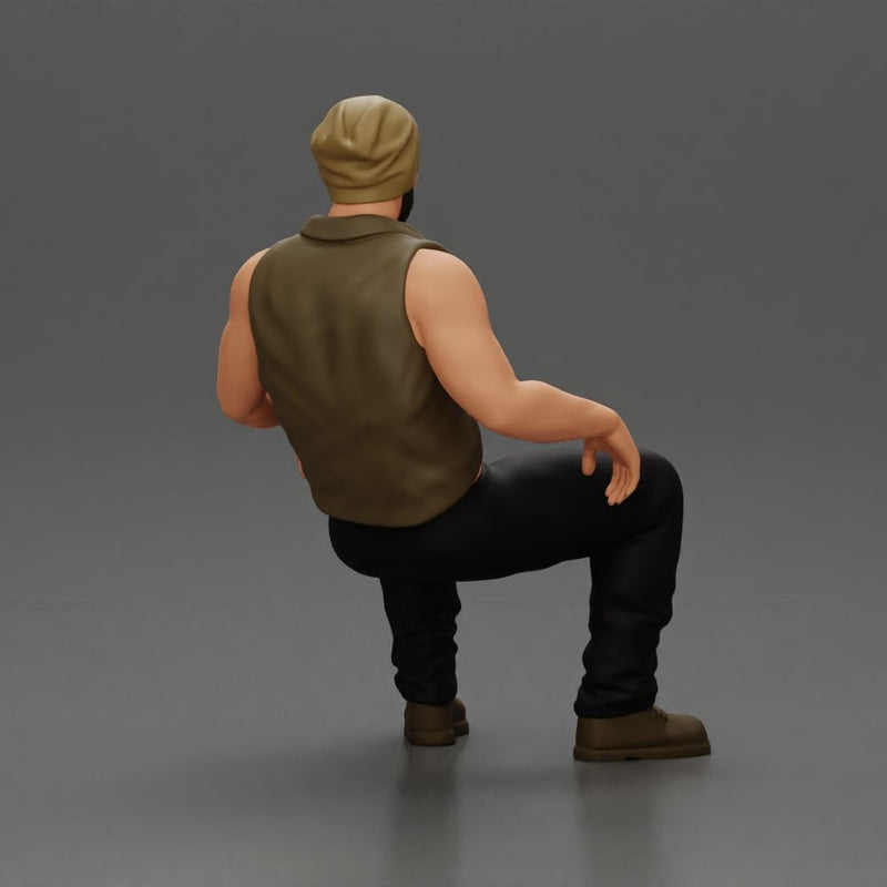 Muscular Bearded Man in Beanie Vest Pants Sitting Casually Relaxed - Only-Games