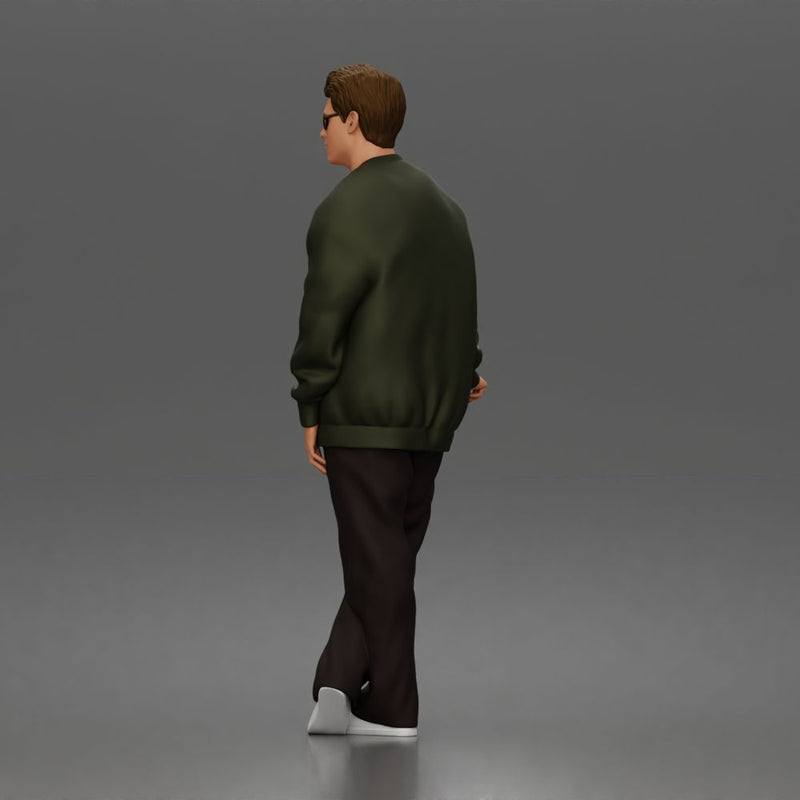 Man standing In Bomber Jacket Tee Trousers Sneakers And Sunglasses