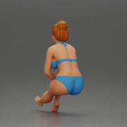 Woman sitting in Blue Bikini Ponders with Relaxed Posture - Only-Games