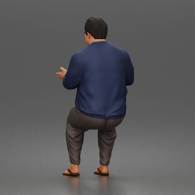 Asian Man sits gesturing while wearing casual sweater pants flip flops comfortably - Only-Games