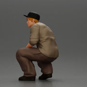 Gangster man crouching in a relaxed pose wearing casual clothing and cap - Only-Games