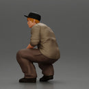 Gangster man crouching in a relaxed pose wearing casual clothing and cap - Only-Games