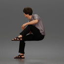 Man Sitting With Knee Bent In Shirt Trousers And Sandals