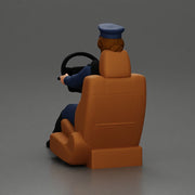 Focused officer in blue uniform driving seated holding steering wheel - Only-Games